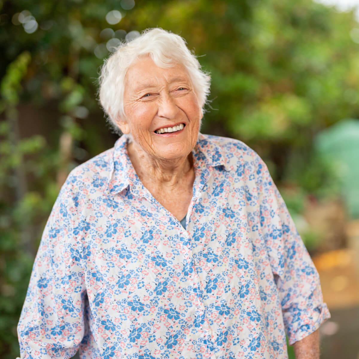 Older woman walking outdoors, smiling