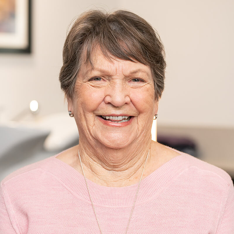 Front on portrait photography of an aged care customer smiling