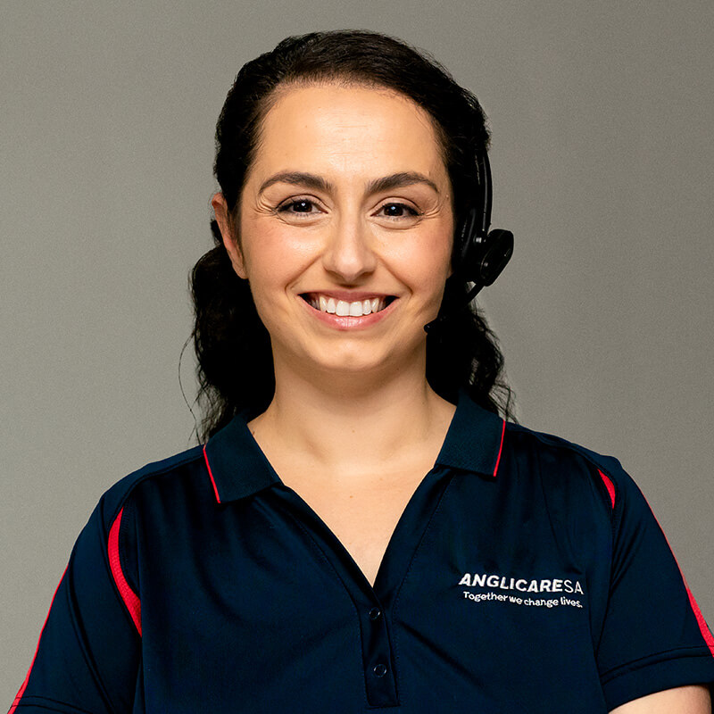 Front on portrait photography of an aged care support working smiling