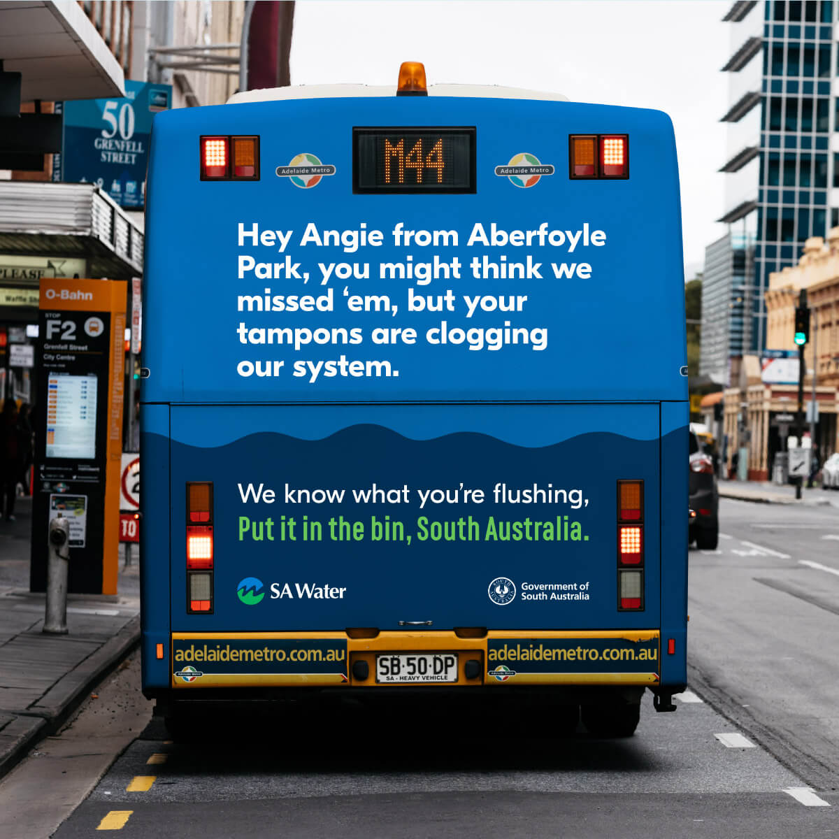 Copy on the back of a bus which reads 'Hey Angie from Aberfoyle Park, you might think we missed 'em, but your tampons are clogging our system.'