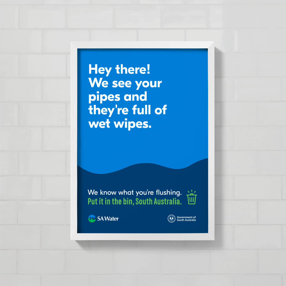 Bathroom stall poster which reads 'Hey there! We se your pipes and they're full of wet wipes'.