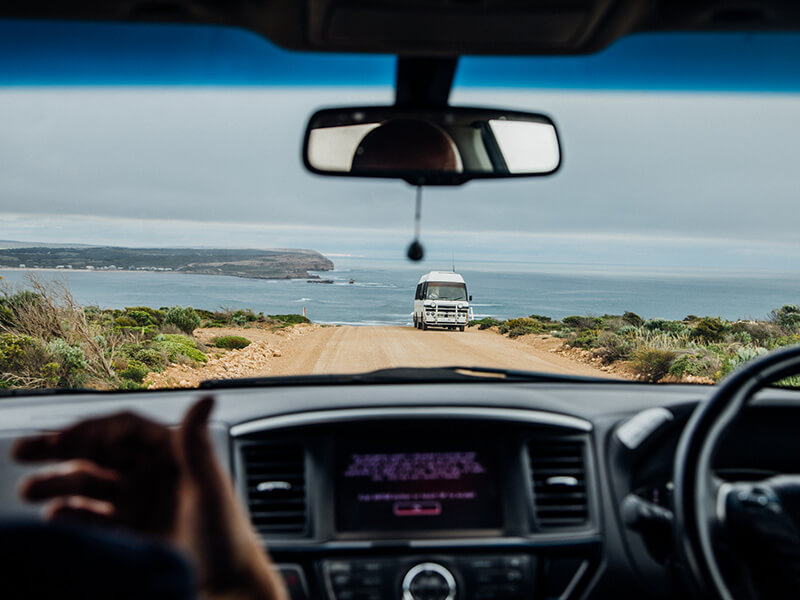 View of the ocean out through a car windscreen