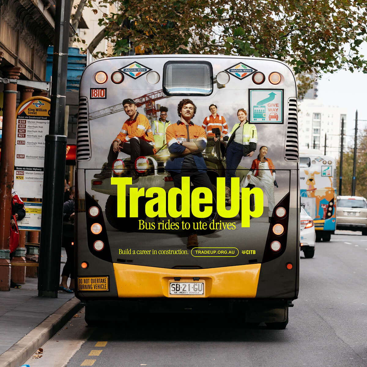 Trade Up ad displayed on the back of a bus.