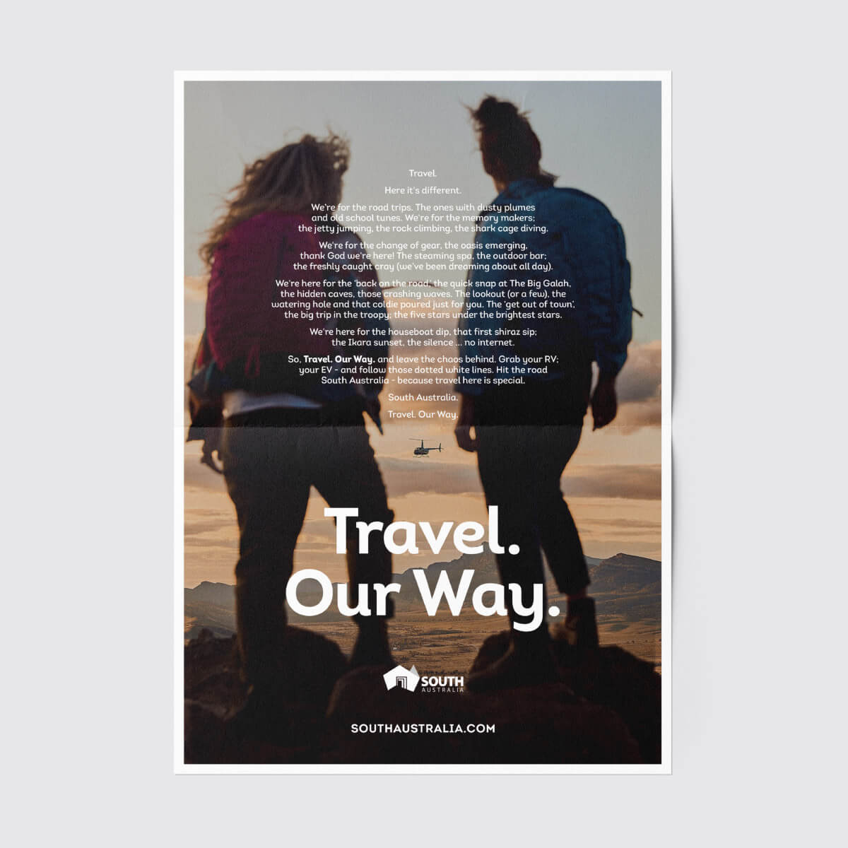 An add intended for print media with a full page image and long form copy printed over the top. The 'Travel Our Way' tagline sits underneath.