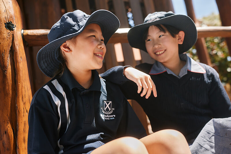 Two St Andrews students bonding in the school yard
